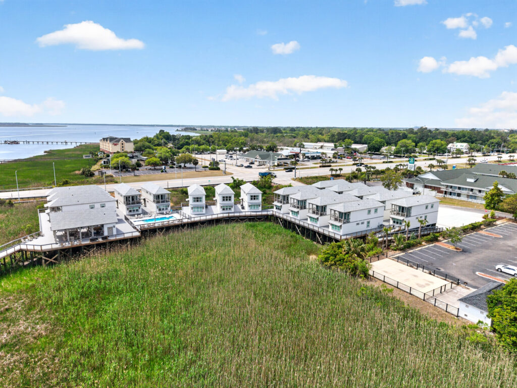 Aerial view of Winyah Bay Club coastal townhome buildings and green lawn