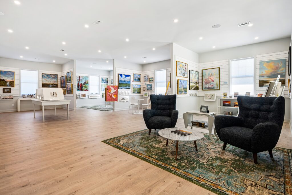 Gray Man Gallery interior with lounge chairs, framed art and wood flooring