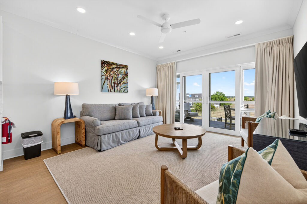 Winyah Bay Club living room with gray sofa and large windows