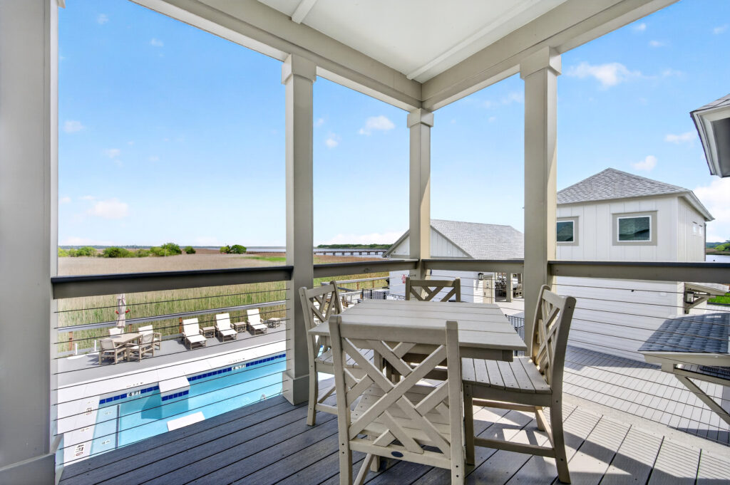 Winyah Bay Club porch dining table with pool and marsh views
