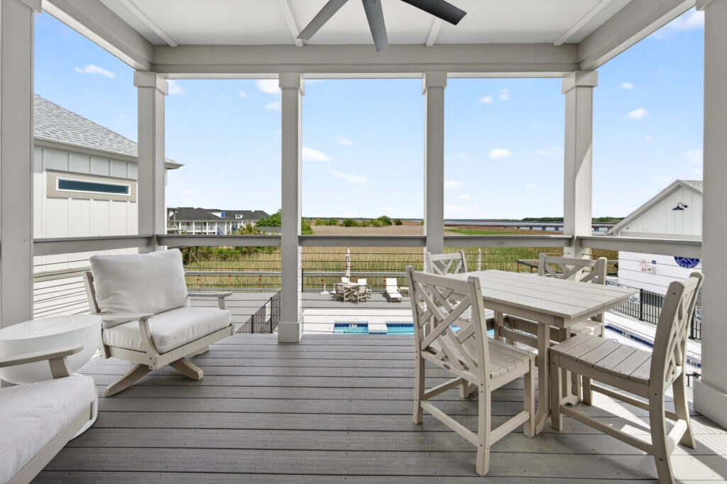 Winyah Bay Club screened porch with seating overlooking the marsh and pool