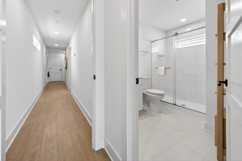 Winyah Bay Club hallway to bathroom with wood-look plank flooring