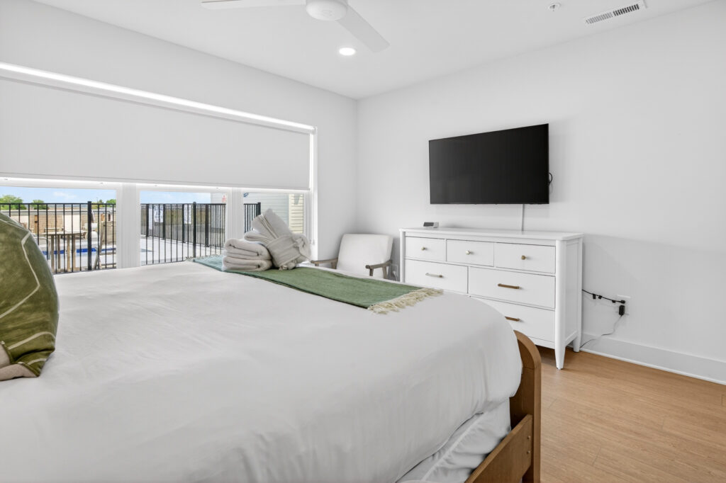 Winyah Bay Club bedroom with wall-mounted TV and white dresser
