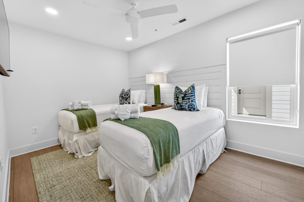 Winyah Bay Club bedroom with green throw blanket and teal pillows