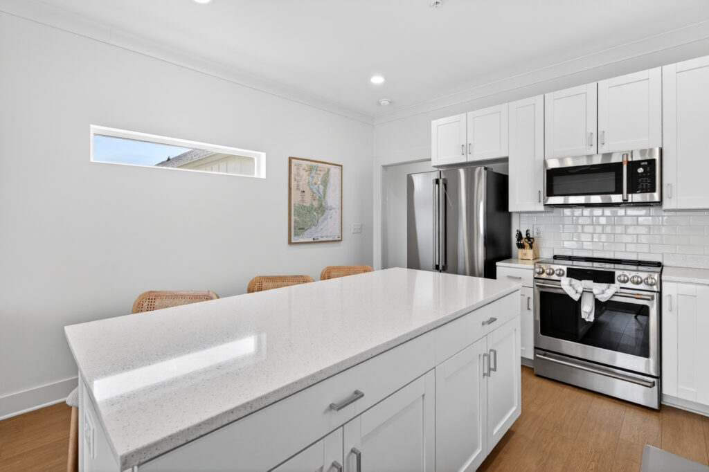 Winyah Bay Club kitchen with white quartz island and stainless refrigerator