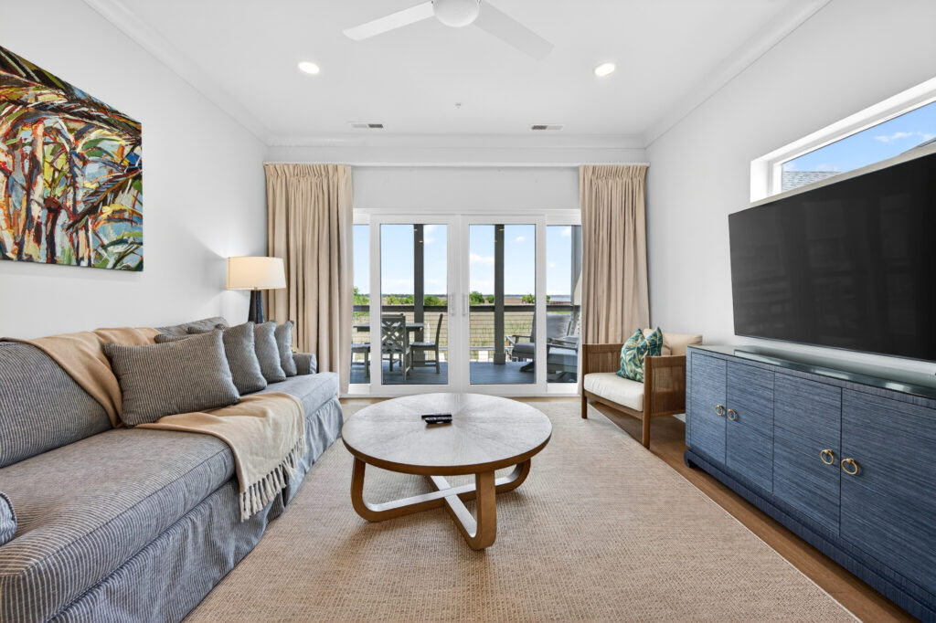 Winyah Bay Club living room with gray sofa and balcony doors
