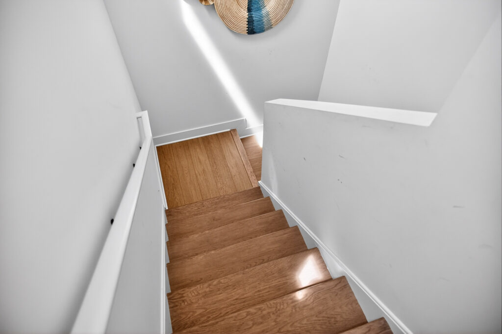 Winyah Bay Club staircase with wood stair treads and white railing