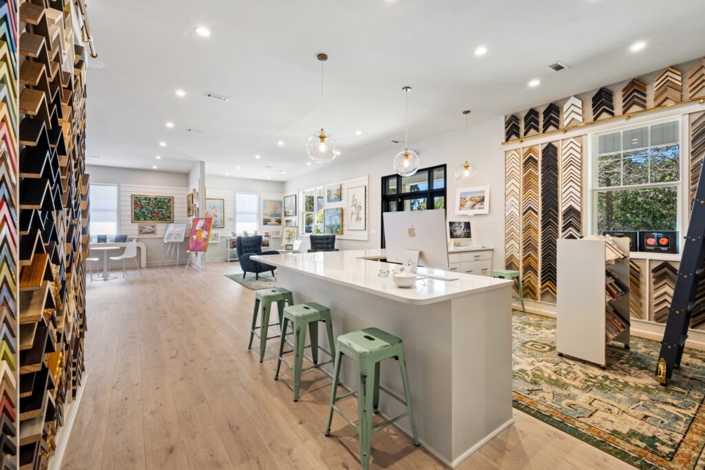 Gray Man Gallery counter with green stools and light wood plank flooring