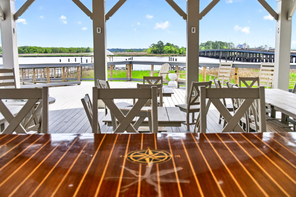 Winyah Bay Club covered deck with outdoor dining table overlooking the water