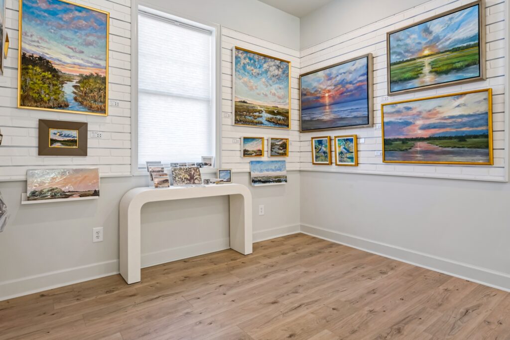 Gray Man Gallery entry area with console table, framed art and light wood plank flooring