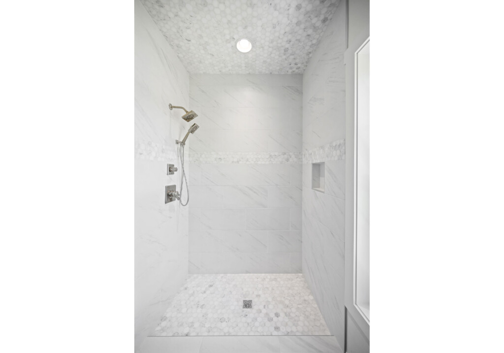 Collins Meadows shower with niche, shower valve and marble-look tile