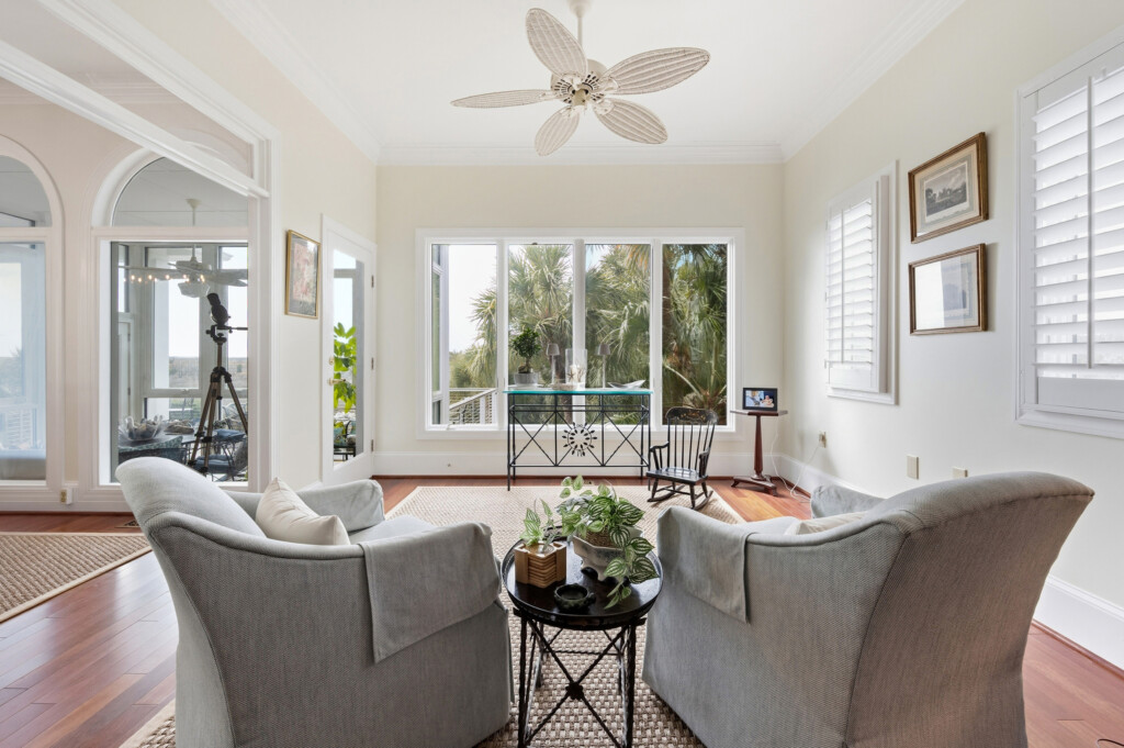 Colony Point living room with gray sofas and large windows, hardwood flooring by J&S Flooring in Georgetown, SC