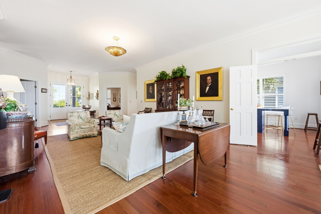 Colony Point formal living room with antique furnishings and hardwood flooring