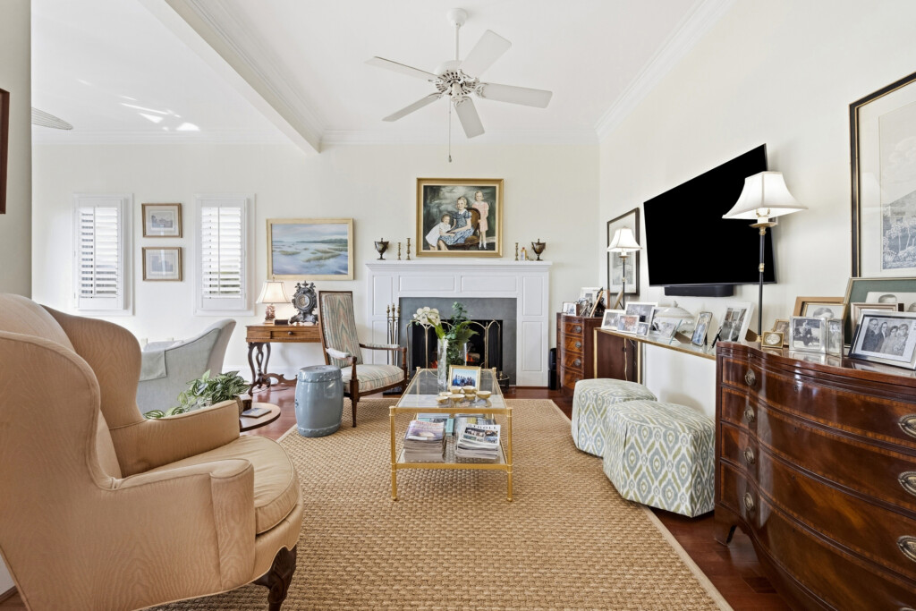 Colony Point living room with fireplace, grand piano and hardwood flooring