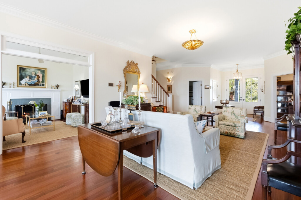 Colony Point open living area with staircase and hardwood flooring