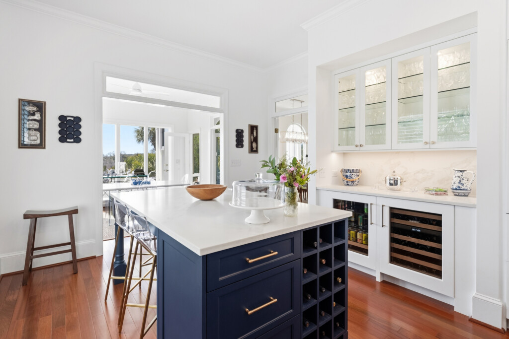 Colony Point kitchen with navy island, wine cooler and glass-front cabinets