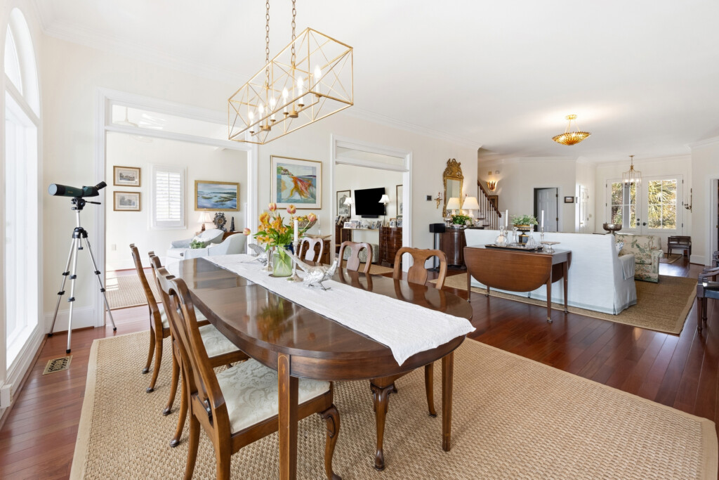 Colony Point dining room open to the living area with hardwood flooring