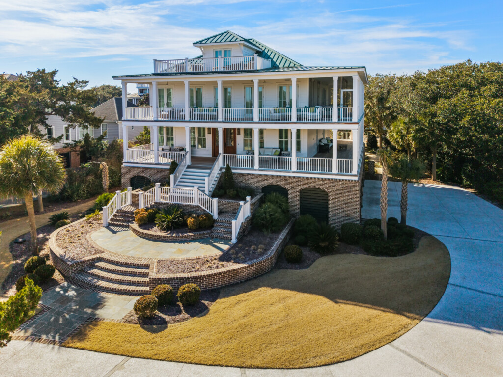 Aerial view of DeBordieu coastal home entrance with double staircase and landscaping