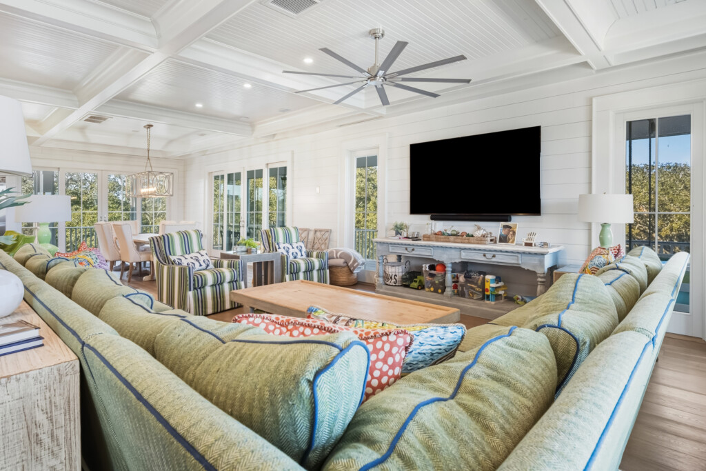 DeBordieu great room with striped chairs, TV and wood flooring