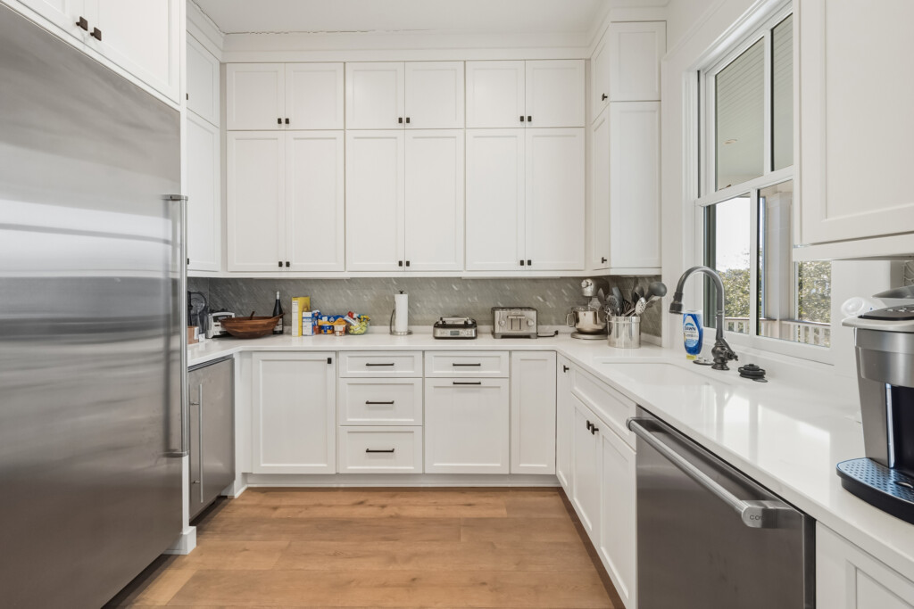 DeBordieu kitchen corner with white cabinets and stainless appliances
