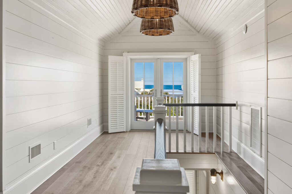 DeBordieu upstairs sitting room with French doors to balcony and wood flooring