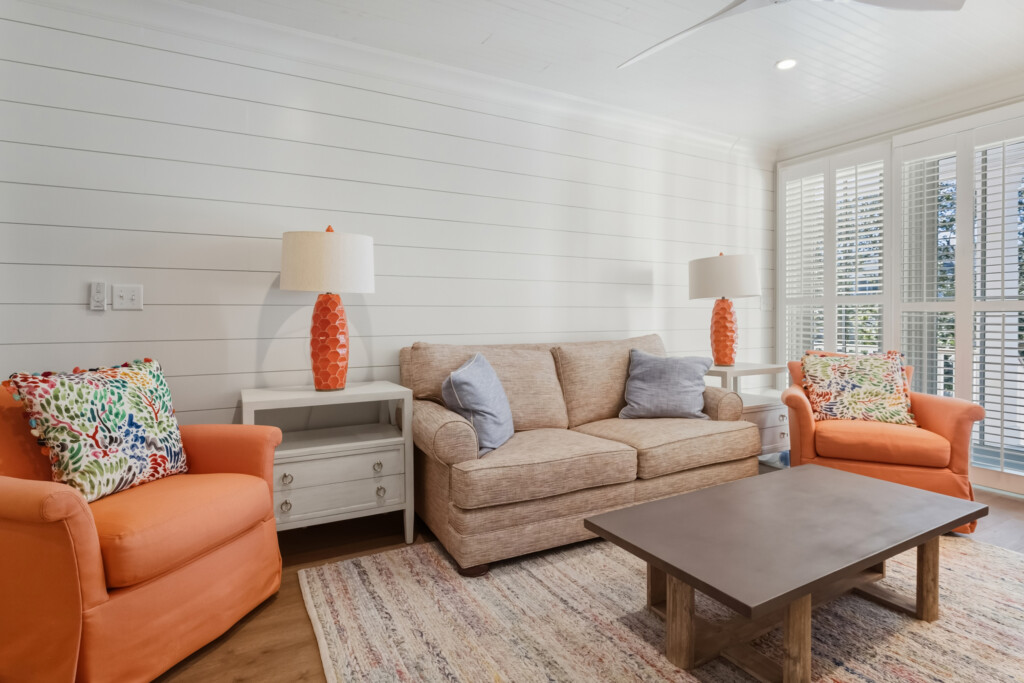 DeBordieu living room sofa with orange lamps and shiplap wall
