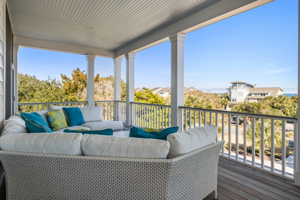 DeBordieu porch with white sofa and teal pillows