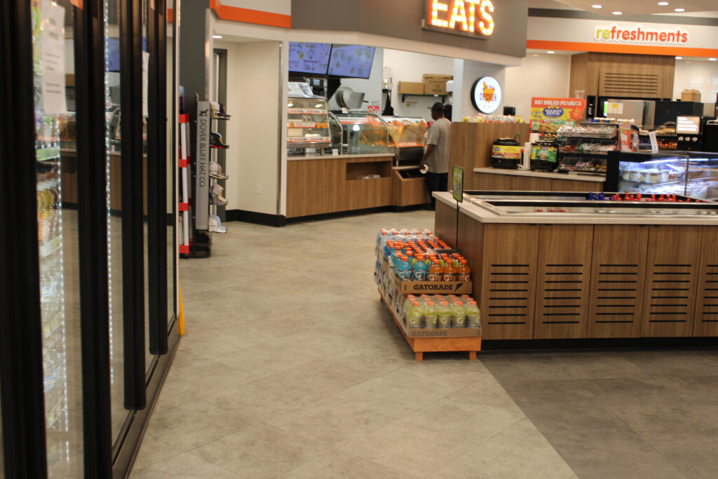 Refuel convenience store in Georgetown, SC with food counter and gray stone-look flooring by J&S Flooring