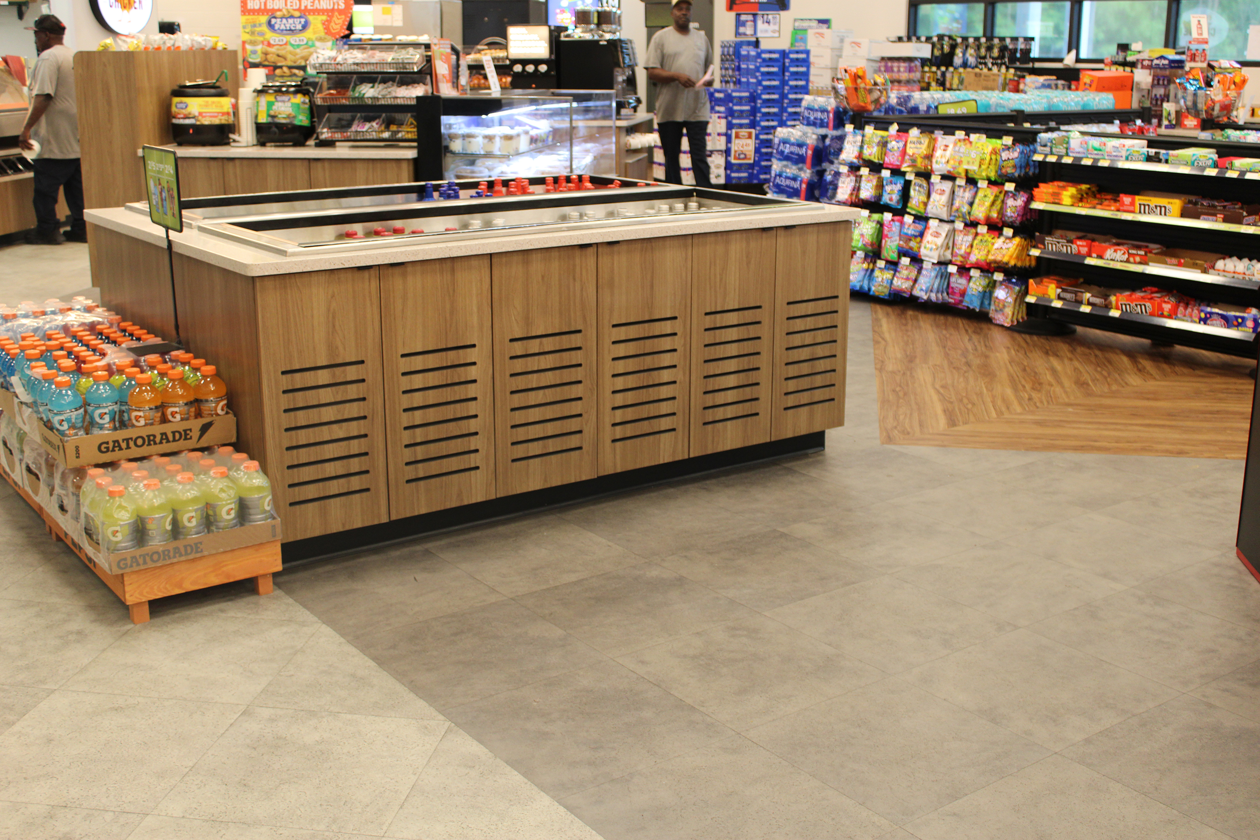 Refuel Georgetown store food display counter with gray stone-look and wood-look plank flooring