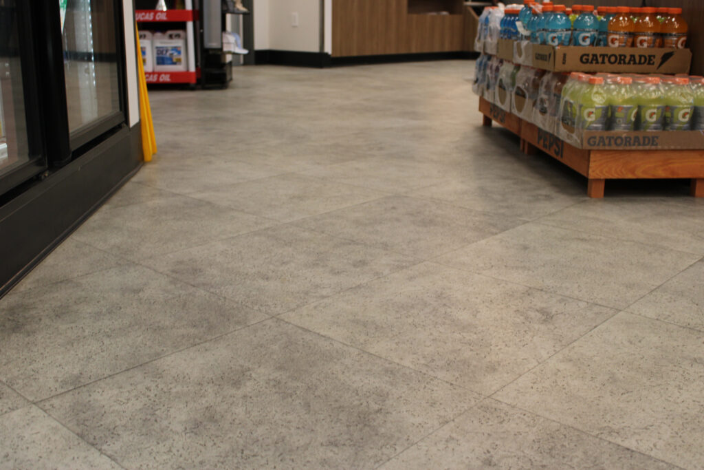 Close-up of gray stone-look commercial flooring at Refuel in Georgetown, SC, installed by J&S Flooring