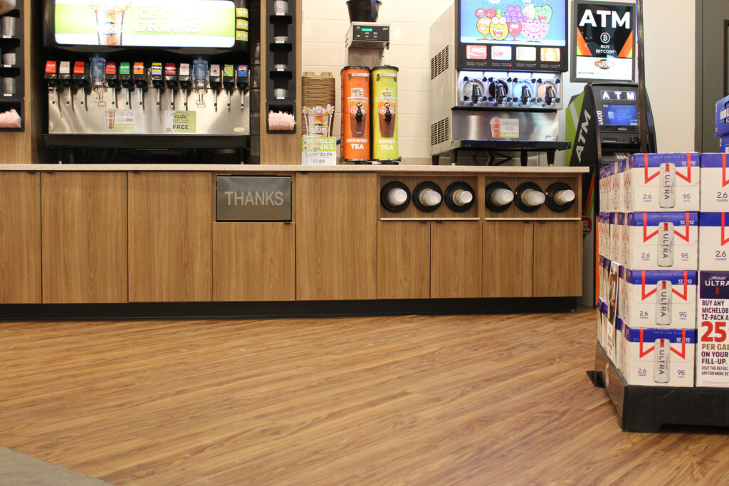 Refuel Georgetown beverage fountain counter with wood-look plank commercial flooring by J&S Flooring