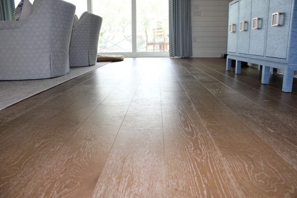 Close-up of wide-plank engineered hardwood flooring in an open living space