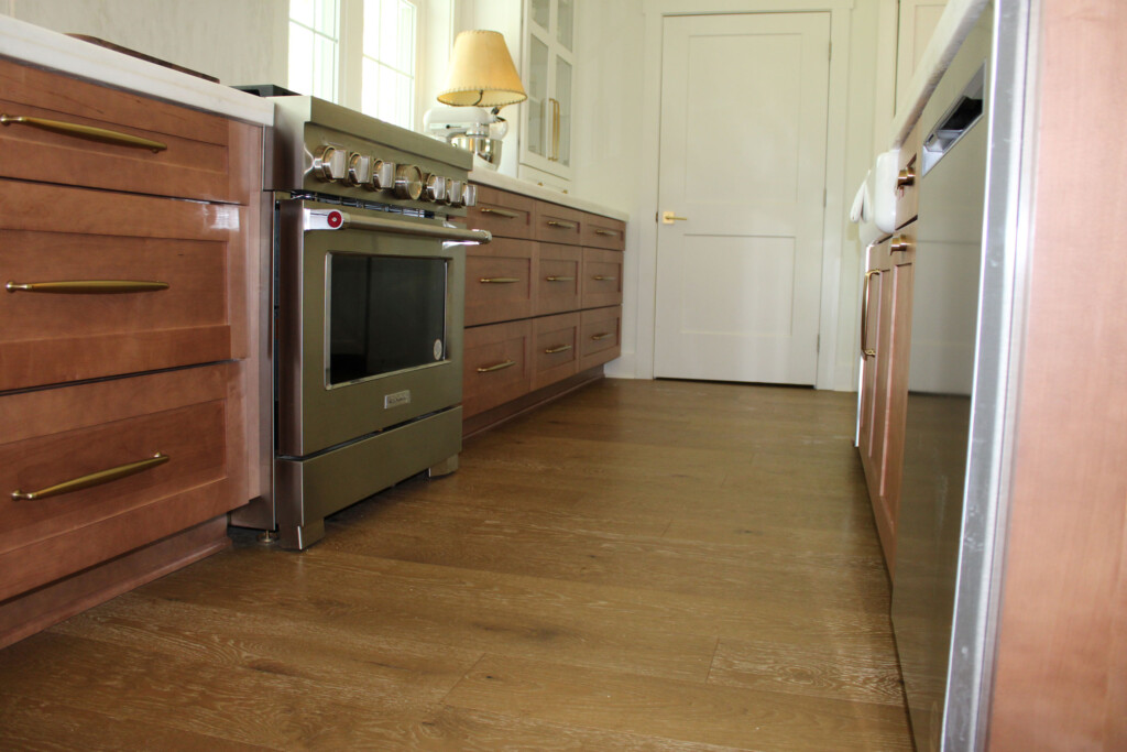 Kitchen with stainless range, dark wood cabinets and hardwood flooring