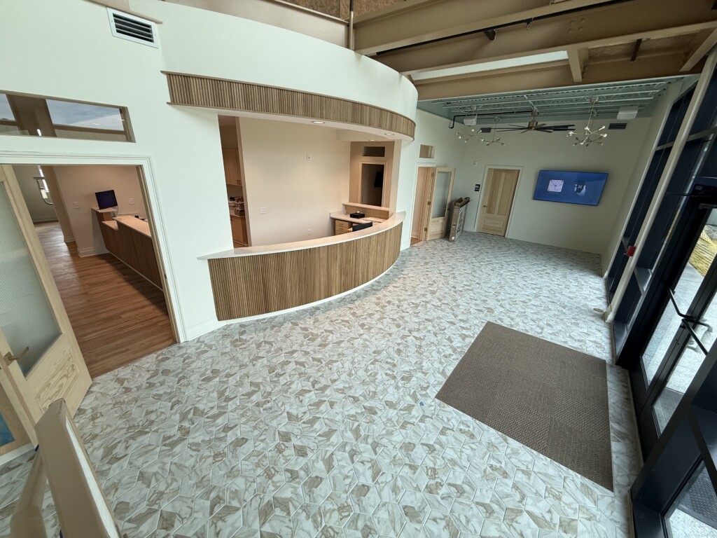 Winyah Dental Group lobby with curved reception desk and stone-look floor tile, flooring by J&S Flooring in Georgetown, SC