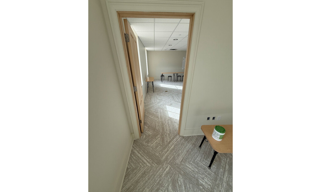 Doorway into a Winyah Dental Group office with patterned gray carpet tile