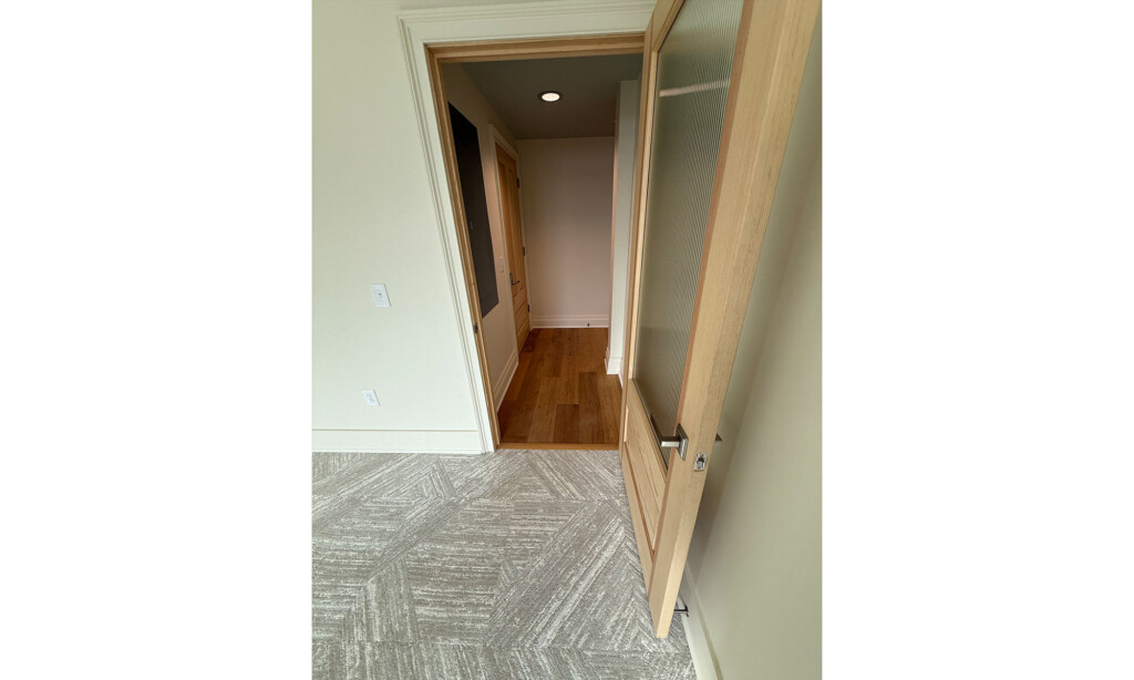 Transition from wood-look plank flooring to patterned carpet tile at Winyah Dental Group