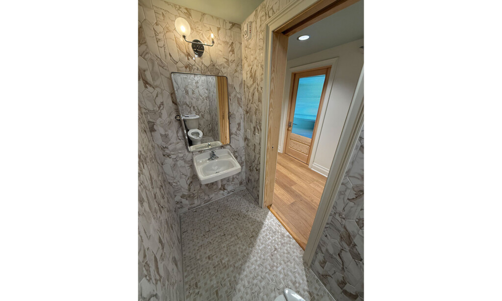 Winyah Dental Group restroom sink with stone-look wall tile and mosaic floor