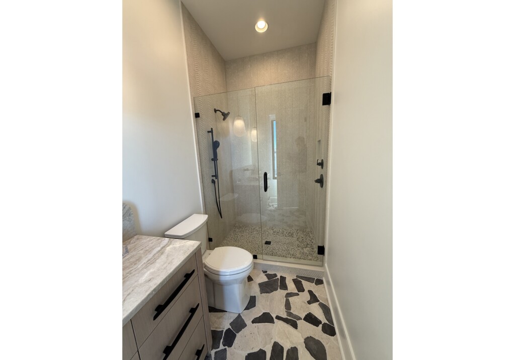 Woodward Project bathroom with glass shower and black-and-white tile floor