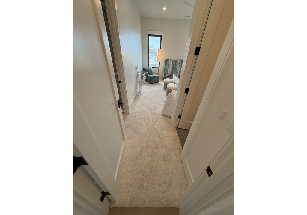 Woodward Project hallway with neutral speckled carpet
