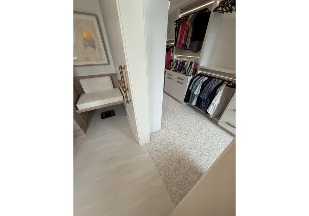 Woodward Project walk-in closet with built-in storage and neutral carpet