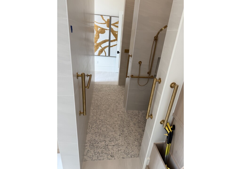 Woodward Project hallway with brass grab bars and neutral carpet
