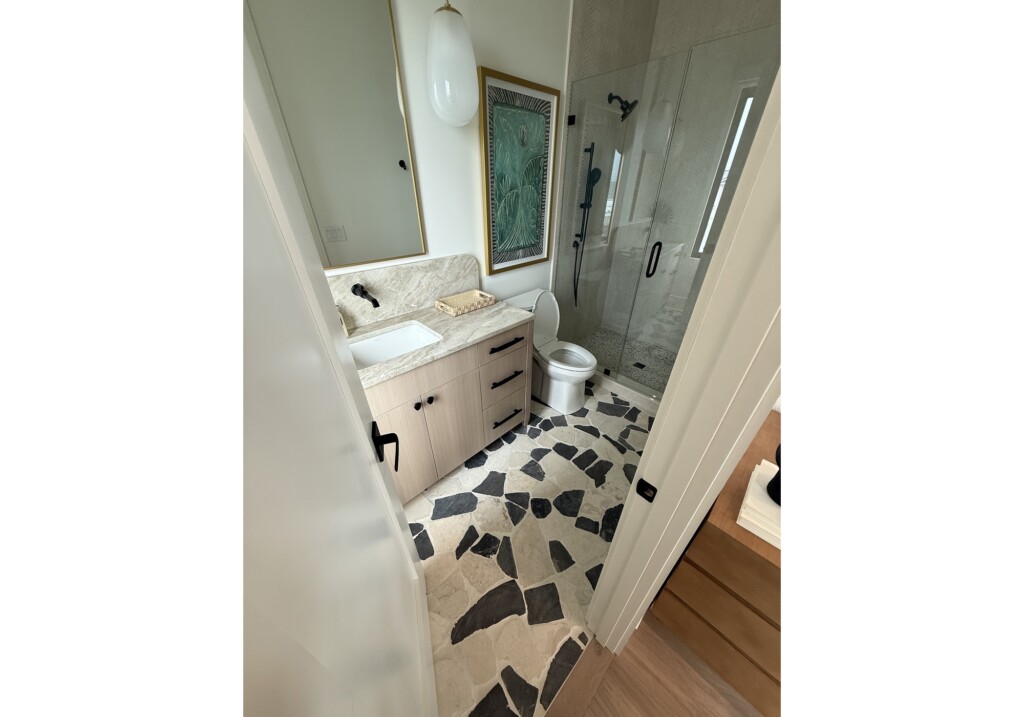 Woodward Project bathroom with black-and-white geometric floor tile and glass shower, tile by J&S Flooring in Georgetown, SC