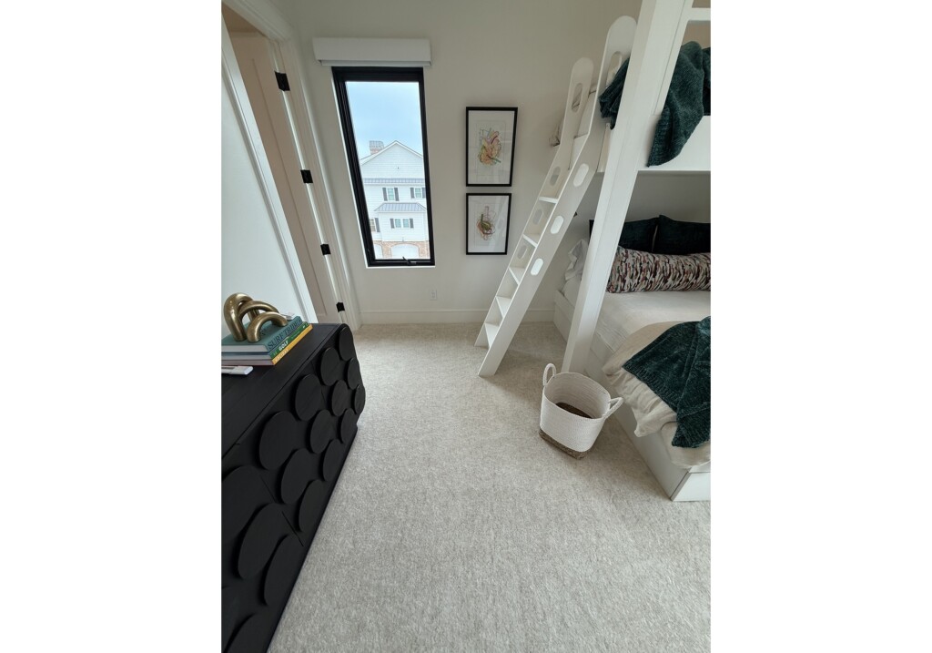Woodward Project bedroom with bunk beds and neutral carpet flooring