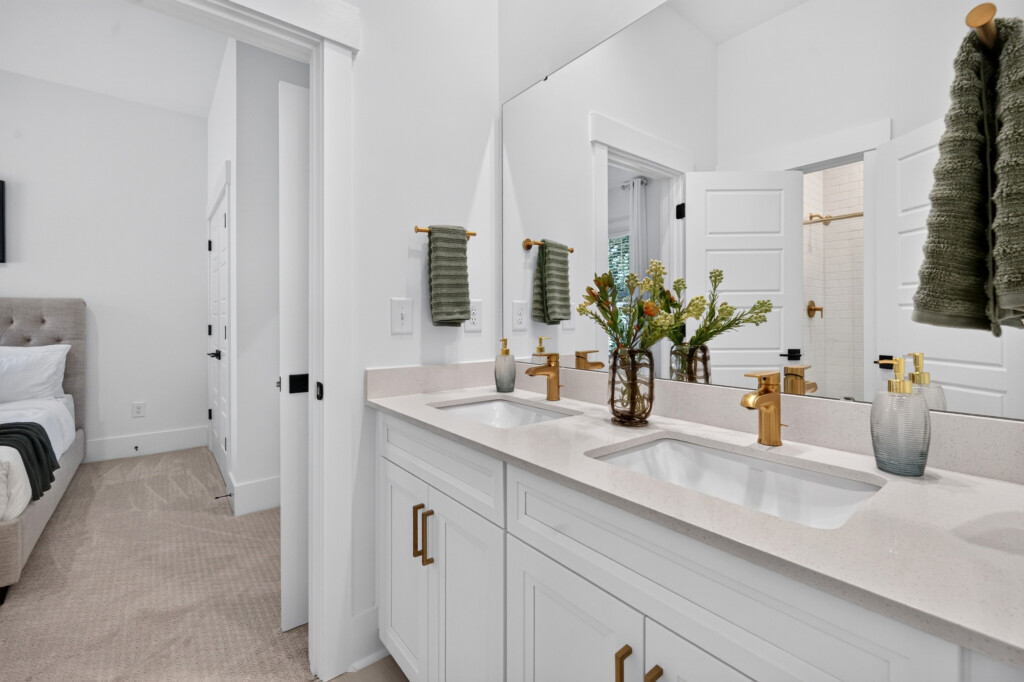Bathroom double vanity with quartz countertop and brass fixtures