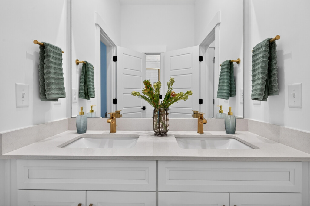 Double vanity with undermount sinks and brass faucets