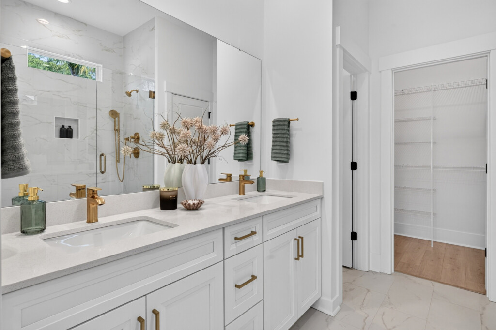 Primary bathroom vanity with marble-look porcelain floor tile