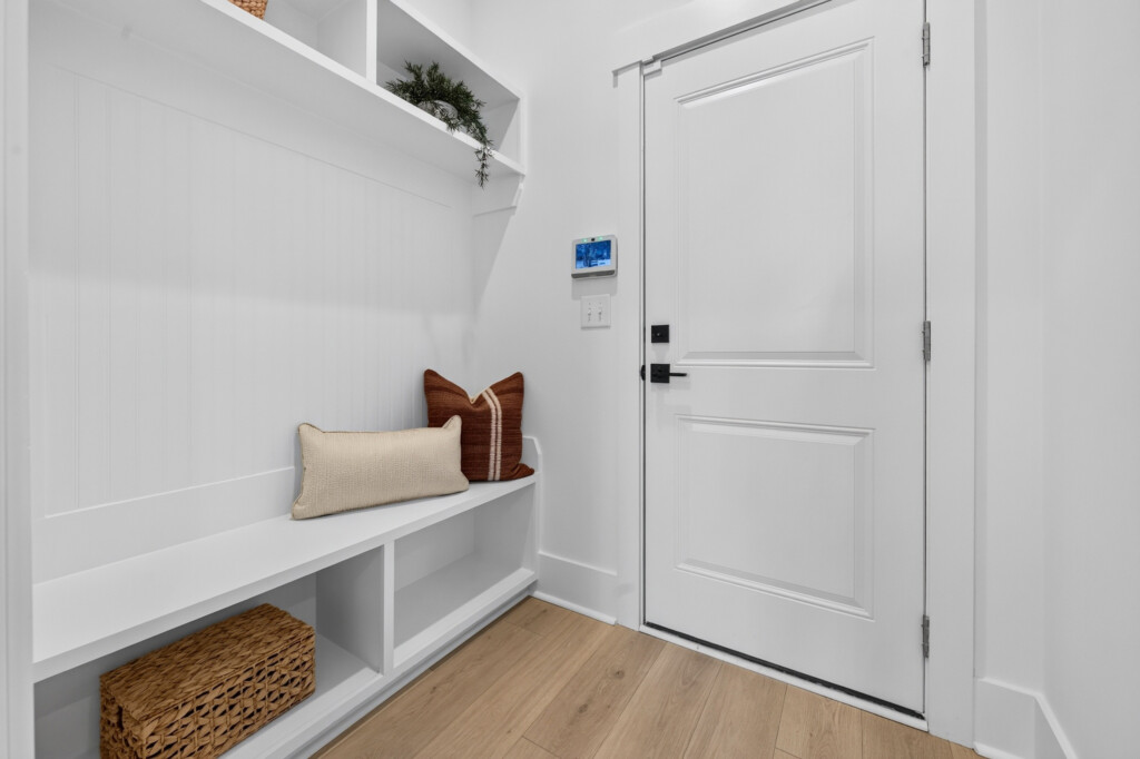 Mudroom bench and storage with light wood-look plank flooring