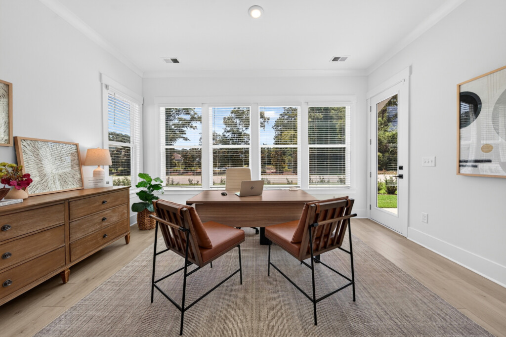 Dining area with leather chairs and light wood-look plank flooring