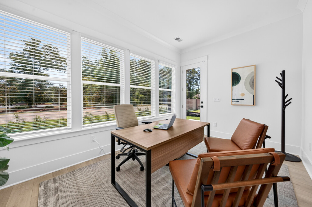 Home office with desk and light wood-look plank flooring