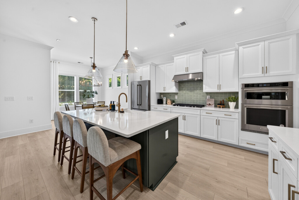 Sanderling Bay kitchen island with bar seating and light wood-look plank flooring